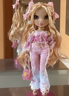 a doll with long blonde hair and pink pants