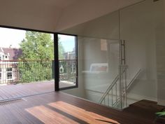 an empty room with sliding glass doors on the outside and wood flooring in front