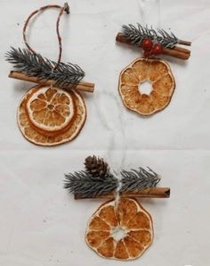 three orange slices and cinnamon stick ornaments