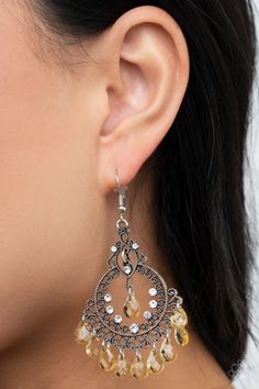 Glassy yellow teardrop beads swing from the bottom and top of an ornate silver teardrop dotted in glittery white rhinestones, creating a whimsical chandelier. Earring attaches to a standard fishhook fitting.

 Sold as one pair of earrings. Whimsical Chandelier, Yellow Chandelier, Teardrop Silver Earrings, Chandelier Earring, Yellow Jewelry, Yellow Earrings, Teardrop Beads, Jewelry Show, Paparazzi Accessories