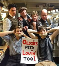 a group of people standing next to each other in front of a sign that says oldies need lovin'too