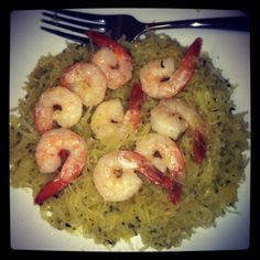 some shrimp and rice on a plate with a fork