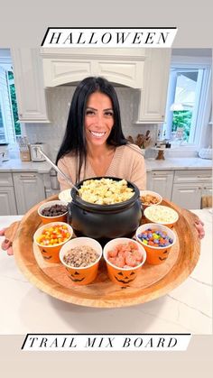 a woman sitting in front of a large bowl filled with food