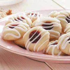 a pink plate topped with cookies covered in white icing