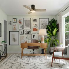 a living room filled with furniture and pictures on the wall next to a desk in front of a window