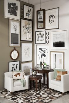 a living room filled with furniture and pictures on the wall