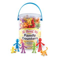 a bucket filled with lots of colorful gummy bears next to small plastic figures in front of it