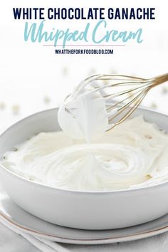 white chocolate ganache whipped cream in a bowl with a whisk on top