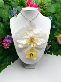 Necklace length = 50 cm Flower width = 9 - 10.5 cm  Flower height = 11-12 cm Materials used = stainless steel findings and real preserved orchid encapsulated in resin.  If you want these necklace longer or shorter please send me a message These beautiful real orchid necklaces can add a elegant touch to your outfit. Wear it with your favorite dress! These makes great unique gifts or a nice detail to your casual wear. Why get flowers that die after a week or two when you can get flowers that will Elegant White Pressed Flower Necklace, Orchid Flower Necklace For Gift, White Flower Necklace With Pressed Flowers, White Pressed Flowers Necklace, White Flower Pendant Necklace With Pressed Flowers, White Pressed Flower Necklace, White Flower Shaped Resin Jewelry, White Resin Flower Jewelry, White Resin Flower-shaped Jewelry