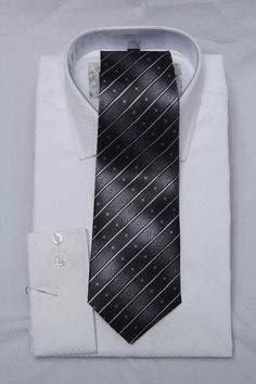 Description White shirt with contrast black tie Classic Black Office Ties, Classic Black Business Tie, Classic Black Ties For Business, Black Ties For Office, Classic Black Tie For Business, Elegant Black Dress Shirt For Semi-formal Occasions, Black Ties For Black-tie Events, Black Standard Tie For Business Casual, Black Suit And Tie Accessories For Business Casual