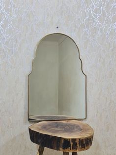 a mirror sitting on top of a wooden table