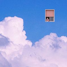 a person is looking out the window of an airplane in the sky with white clouds