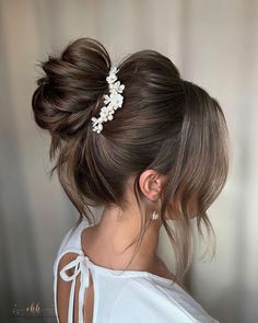 a woman with her hair in a low bun