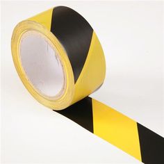 a roll of black and yellow hazard tape