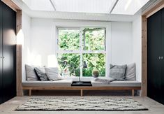 a living room with two couches and a coffee table in front of a window