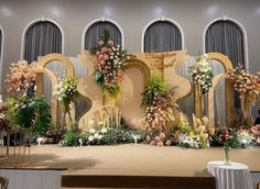 a wedding stage decorated with flowers and greenery