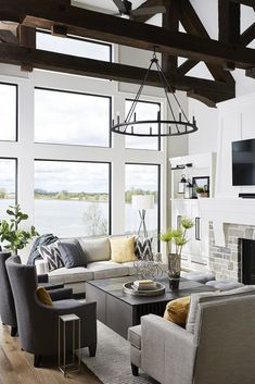 a living room filled with furniture and a flat screen tv mounted on the wall above a fireplace