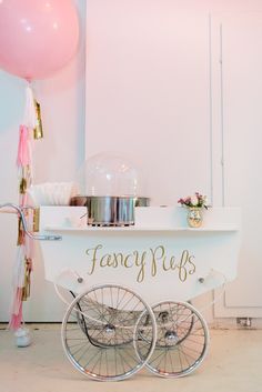 a fancy buffet cart with balloons and confetti