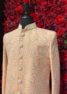 Make a grand entrance with the Chaitanya Sherwani from Vama Designs, a masterpiece of elegance and craftsmanship. Tailored for the modern groom, this sherwani combines tradition with contemporary aesthetics, featuring delicate floral embroidery on premium peach fabric. Ideal for weddings and special occasions, the Chaitanya Sherwani adds a touch of sophistication to your attire, setting you apart with its timeless design and luxurious detailing. Key Features: Color - Silky Peach With White Flowe Wedding Sherwani With Floral Embroidery In Traditional Drape, Wedding Sherwani With Floral Embroidery And Traditional Drape, Wedding Sherwani With Floral Embroidery, Peach Embroidered Kurta For Wedding, Peach Traditional Wear With Intricate Embroidery For Reception, Floral Embroidered Sherwani For Reception During Eid, Elegant Peach Traditional Wear With Intricate Embroidery, Elegant Sherwani With Chikankari Embroidery For Designer Wear, Pink Bandhgala With Intricate Embroidery For Wedding