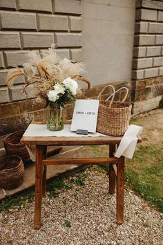 a wooden table topped with a vase filled with flowers