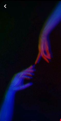 two hands touching each other with colored light coming from them in front of black background