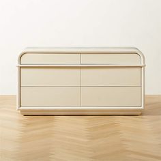 a white dresser sitting on top of a wooden floor