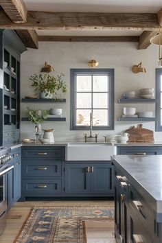 a kitchen with blue cabinets and white counter tops, an area rug and open shelving