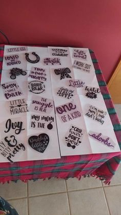 many different types of stickers are on the table in front of a pink wall