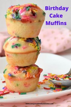 three birthday cake muffins stacked on top of each other