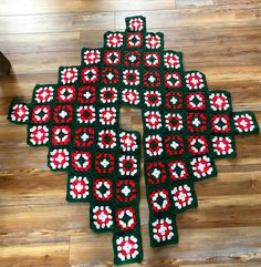 a crocheted christmas tree is on the floor