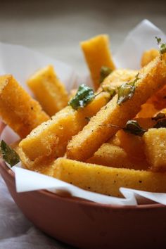 a bowl filled with fried food on top of a table