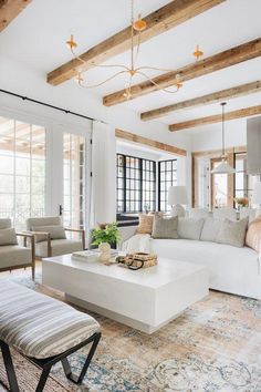 a living room filled with furniture and lots of windows