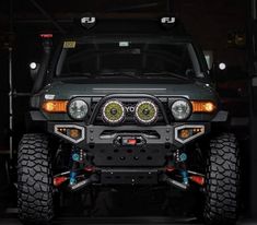 the front end of a jeep with lights on and bumper mounted to it's bumper