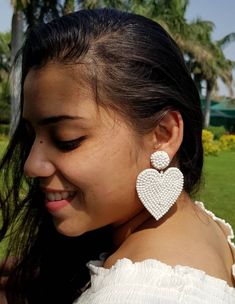 "Handmade white beaded Heart shape embroidered bridal earring Purely handmade seed beads embroidered heart earring looks so great. An ideal gift for bridesmaids and brides. Earrings measure about approx. 2.10\" long and 2.10\" wide. PS: Carnation jewelry is handmade & handcrafted in India hence there is a possibility of a slight or small imperfection due to the fact that these are made by hand. I still make sure that every piece made here is perfect to look at. For more details, please see o White Heart Beads Jewelry For Party, Heart-shaped Beaded Earrings For Party, Beaded Dangle Heart Earrings For Parties, Elegant Beaded Earrings With Heart Beads For Parties, Heart-shaped Beaded Party Earrings, White Heart Beads Earrings For Party, White Heart Bead Earrings For Party, Elegant Beaded Heart Earrings For Party, Wedding Beaded Heart-shaped Earrings