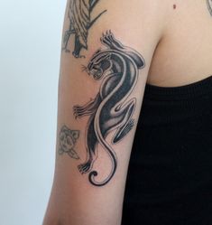 a woman with a tattoo on her arm has a dragon and tiger design on it