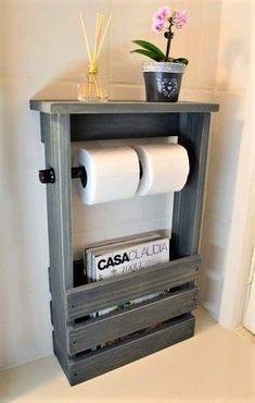 a shelf with two rolls of toilet paper on it and a potted plant next to it