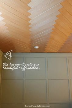 the ceiling is covered with wood planks and has writing on it that says, this basement ceiling is beautiful & splendid