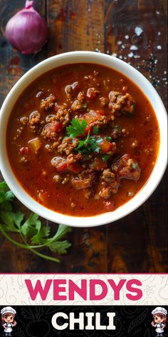 a bowl of chili with meat and cilantro in it on a wooden table