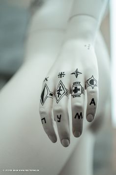 a person's hand with tattoos on it