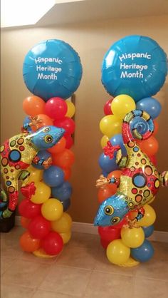 two tall blue and yellow balloons with fish on them