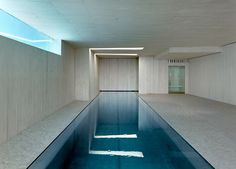 an empty indoor swimming pool with blue water