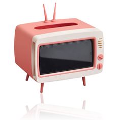 an old fashioned tv sitting on top of a white table