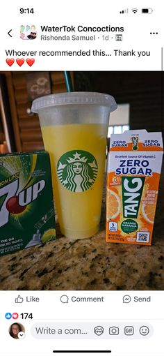 the starbucks drink is next to two packets of orange juice