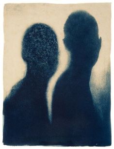 an image of two people that are in the dark with one person's shadow