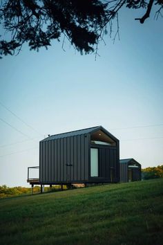 a small house sitting on top of a lush green field