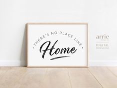 there's no place like home printable poster in wooden frame on wood floor