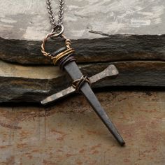 This Men's Cross Necklace Rusty Nails Pendant is handmade from vintage rusty nails. The cross makes a great gift for men or boys. Also great for First Communion or Confirmation gift.The two nails of the cross are welded and hand wound together with copper wire and sealed with a clear satin finish to maintain the rustic vintage look.Size of pendant: Height: 2 inches (5 cm) Width: 1 1/4 inches (3.2 cm)NOTE: Each cross is entirely made by hand, therefore each one is unique and can differ slightly f Diy Cross Pendant, Diy Cross Necklace, Cross Made Of Nails, Deer Horn Jewelry, Metal Crosses, Nail Cross Necklace, Nails Pendant, Rusty Nails, Cross Necklace For Men