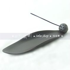 a black object with a ladybug on it's back and the words souffle shop written in chinese