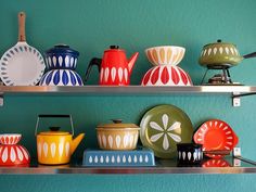 two shelves filled with plates and bowls on top of each other