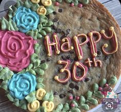 a birthday cake decorated with flowers and the words happy 50th on it's top